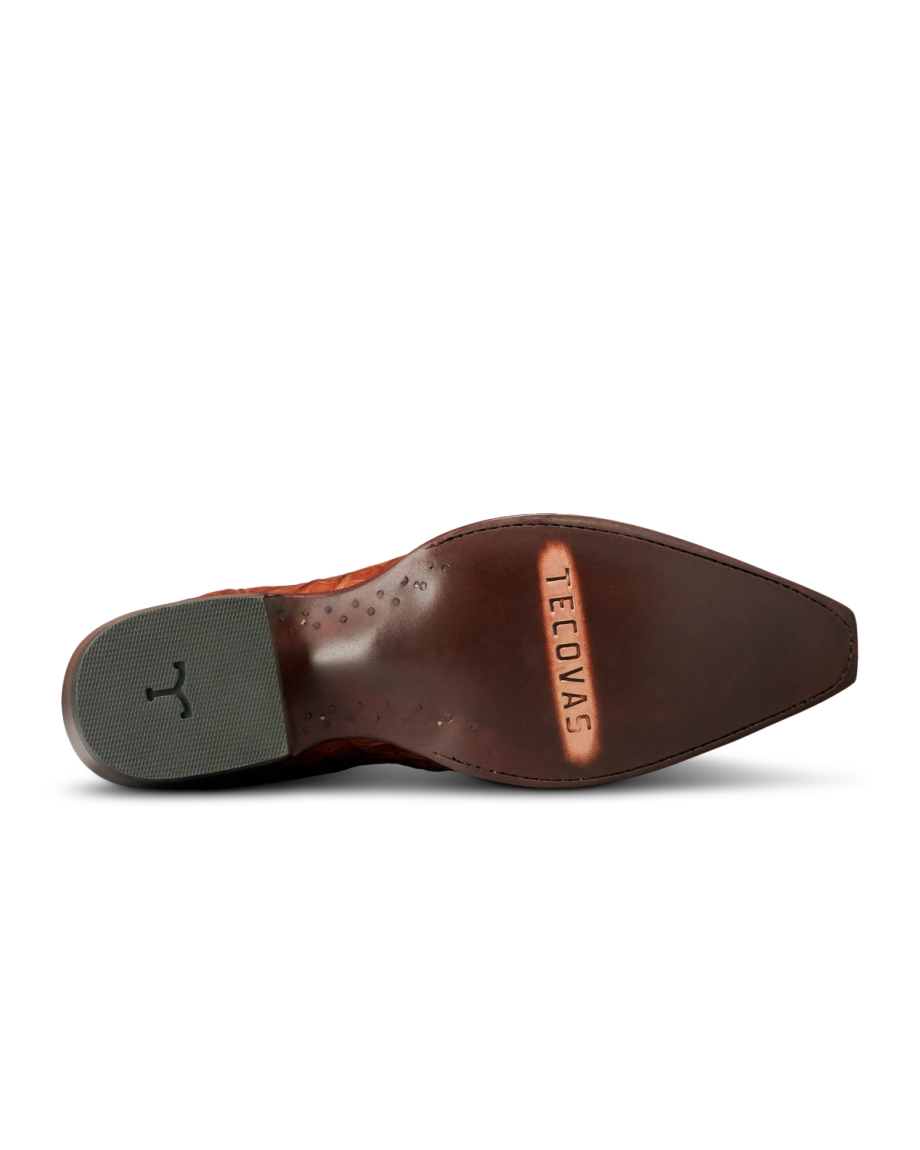 The underside of a brown leather dress shoe with “Tecovas” engraved on the sole and a textured rubber heel pad, crafted in the refined style of The Garrett Hornback Caiman in rich Pecan.