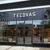 Storefront of Tecovas, featuring large glass windows and double glass doors, with the brand name displayed above the entrance on a black sign.