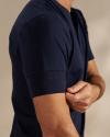 Man wearing the navy henley in a photo studio