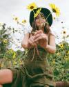 Woman wearing Kristopher Brock India Dress in flower field - Tecovas 