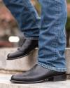 close up picture of Earl midnight black cowboy boots on a man's feet