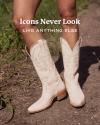 A person wearing white cowboy boots stands on a dirt path. Text above reads, "Icons Never Look Like Anything Else.