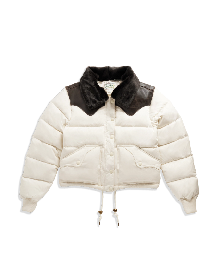 White puffer jacket with a black faux fur collar, black shoulder accents, front snap buttons, two front pockets, and drawstrings at the hem.