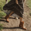 woman wearing booties and a dress