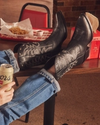 woman in midnight black mid-calf cowgirl boots