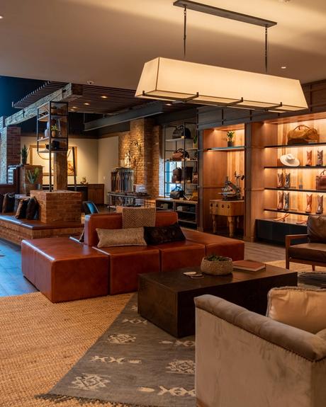 Image of the inside of the Main Street Tecovas Store wall of boots and couches