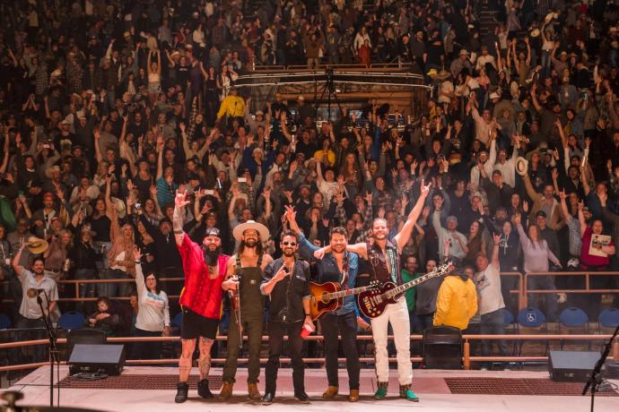 Shane Smith & The Saints standing on stage at a concert