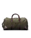 A green canvas duffle bag with brown leather handles and accents, set against a black background.