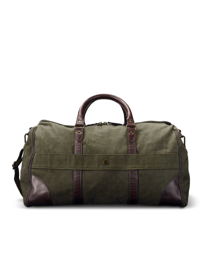 A green canvas duffle bag with brown leather handles and accents, set against a black background.