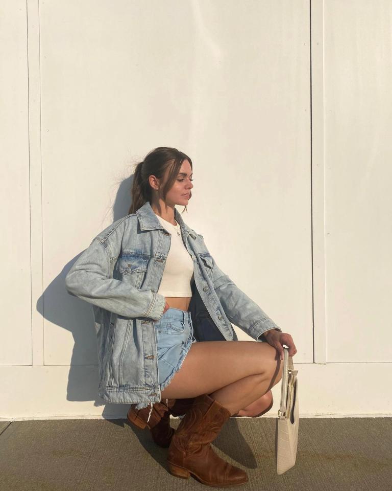 Woman crouching during golden hour wearing a denim outfit and The Jamie in Scotch
