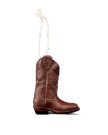 A small brown cowboy boot ornament with white stitching details, hanging by a white string against a plain white background.