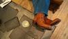 Man relaxing with boots up on a coffee table