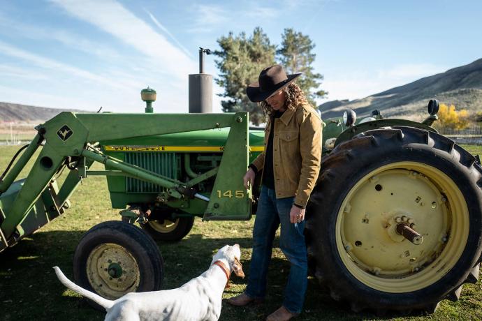 man and a dog and a tractor