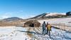 a couple walking into a house on the mountain