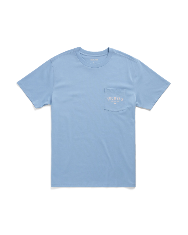 Light blue short-sleeve T-shirt with a chest pocket on the left side featuring the white Tecovas logo.