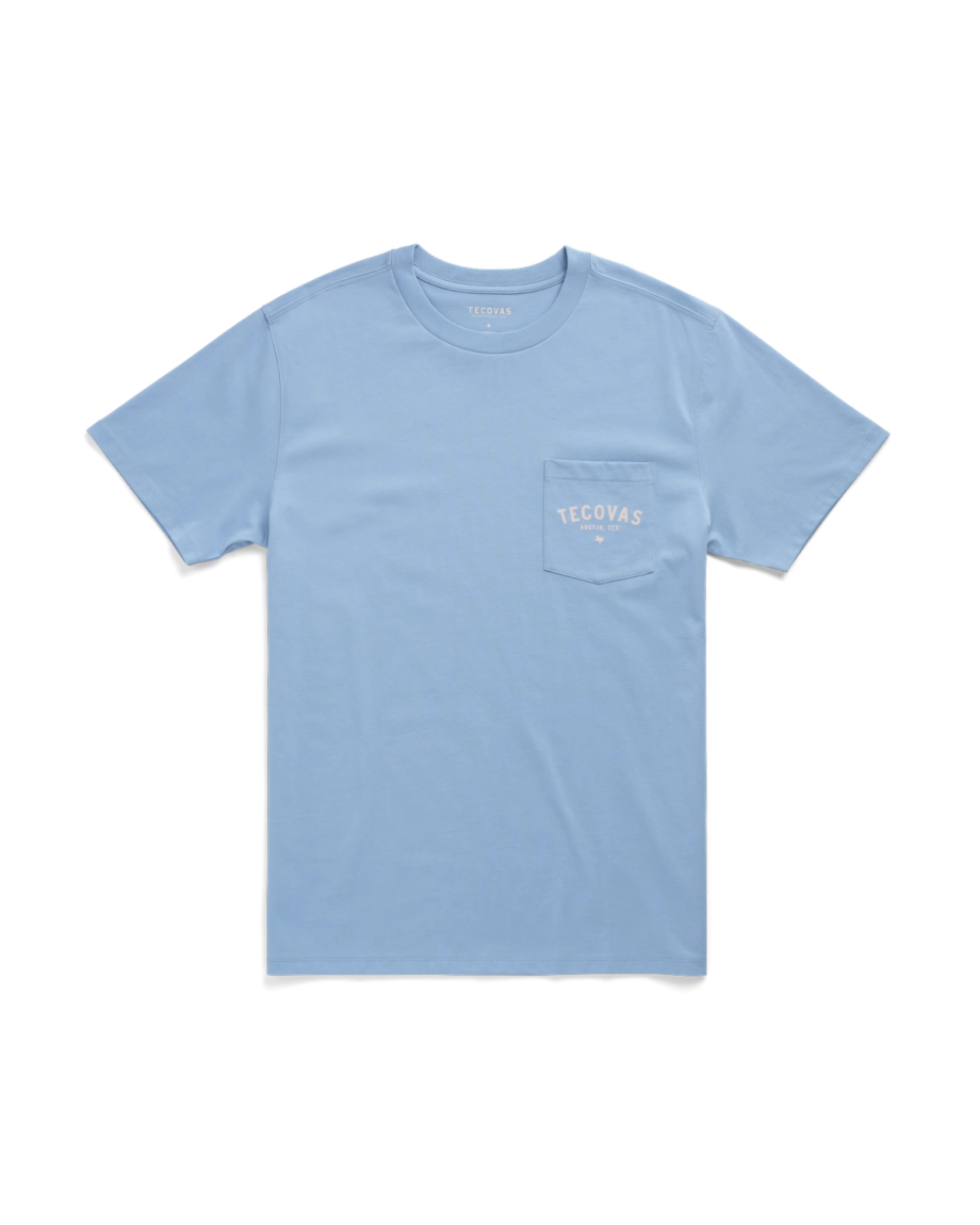Light blue short-sleeve T-shirt with a chest pocket on the left side featuring the white Tecovas logo.