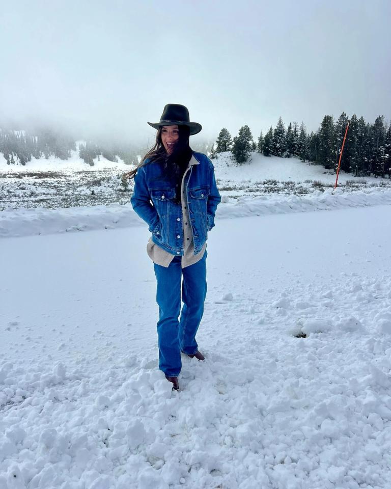 Woman in the snow wearing an all denim outfit in the mountains