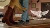 A shot from the knees down of men and female cowboy boots dancing