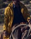 Cowboy wearing the Storm Chaser Jacket riding a horse