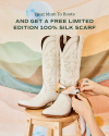 A pair of white cowboy boots displayed upright, with hands tying a silk scarf around them, against a pastel striped background. text overhead promotes a limited edition gift.