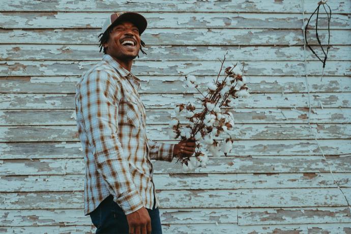 man holding raw cotton