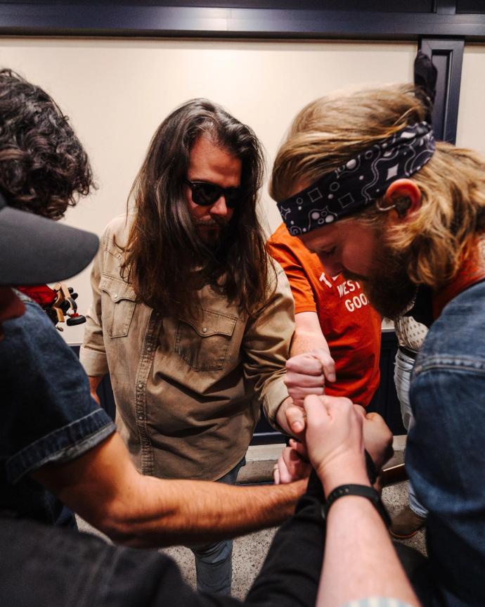 Band huddling together before a show