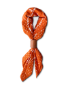 Orange scarf with white polka dots, tied in a loop with a brown leather ring.