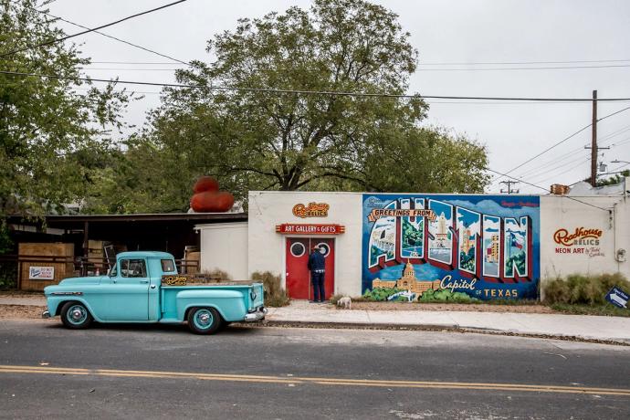 a graffiti wall with a turquoise pick up truck