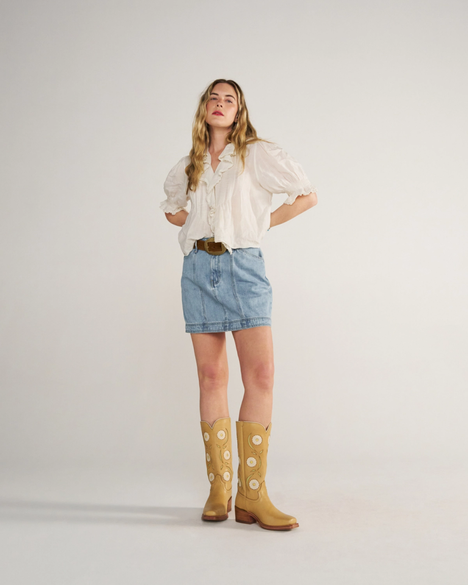 Full view of Women's High-Rise Denim Mini Skirt - Light Wash on model