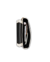 Top view of an open black and white purse containing a smartphone, a tube of lip balm, a pen, and a small patterned wallet against a black background.