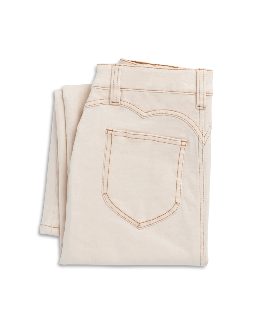 Folded pair of off-white jeans with visible brown stitching on the pocket, placed on a white background.