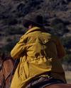 Cowboy wearing the Storm Chaser jacket on a horse