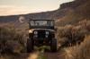 couple with a dog in a jeep