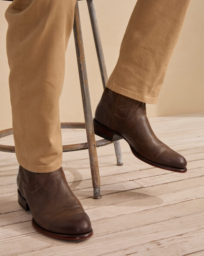 Closeup of the Earl Cafe on a man sitting in a photo studio