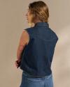 Back view of woman wearing the denim cutoff top in a photo studio