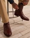 man wearing the zane dark brown mahogany ostrich zip boots