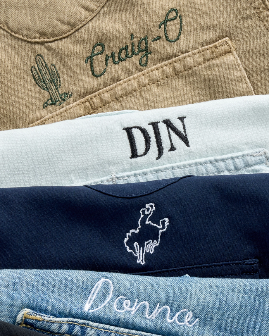 Embroider stack of shirts with different icons and symbols