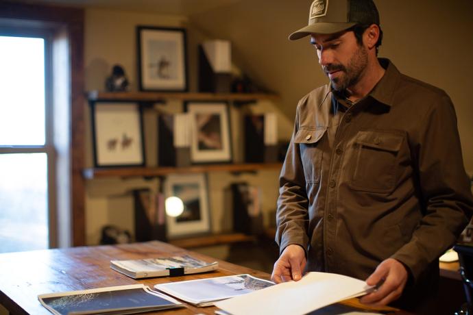 man arranging papers on a table