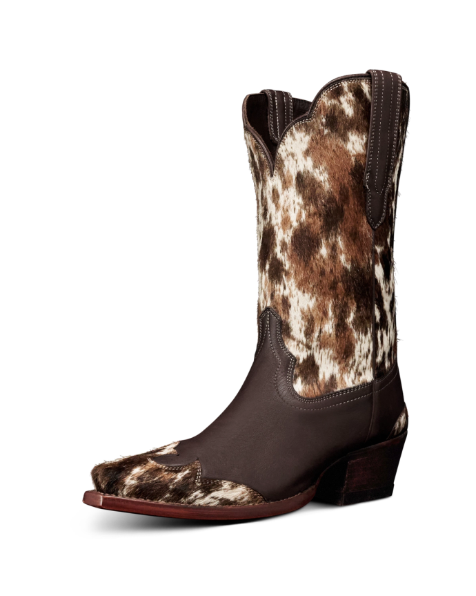 The Sadie in Hair on Hide Hair on Hide / Cowhide. A single cowboy boot with a brown leather base and a speckled Hair on Hide / Cowhide upper, featuring a pointed toe and stacked heel.