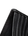 Close-up of a black leather wallet corner, showing stitching and vertical grooves, against a black background.