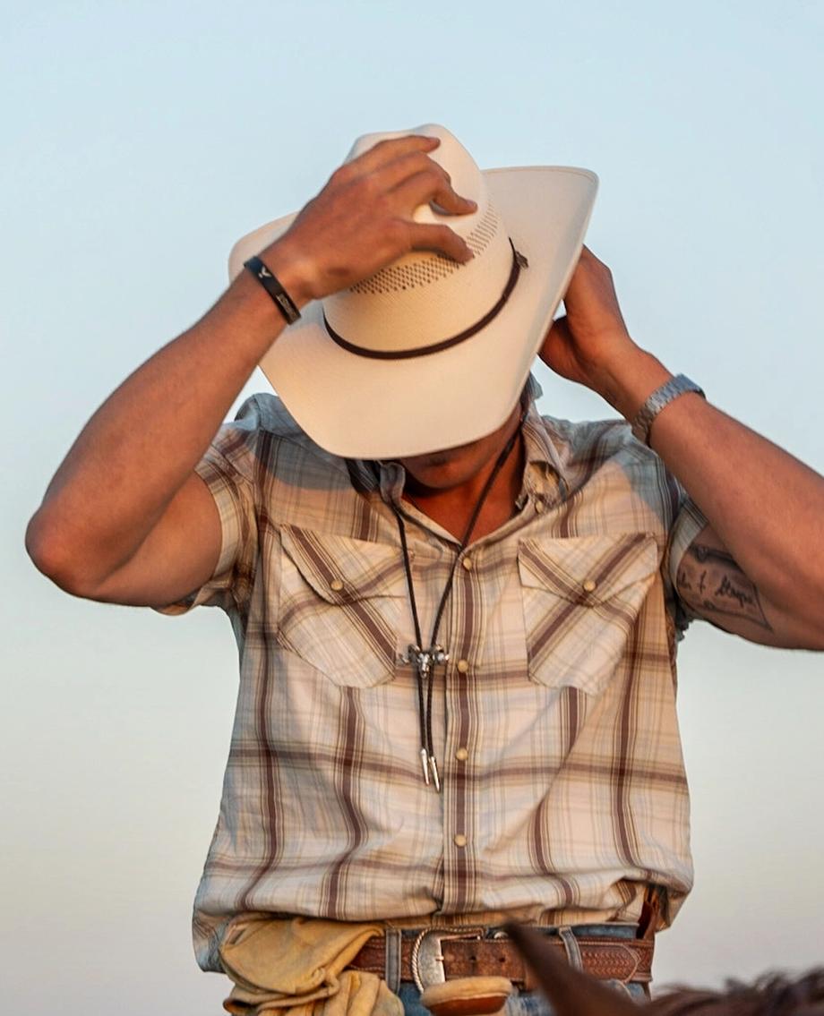 Man wearing Cattleman Cowboy Hat at Golden Hour.