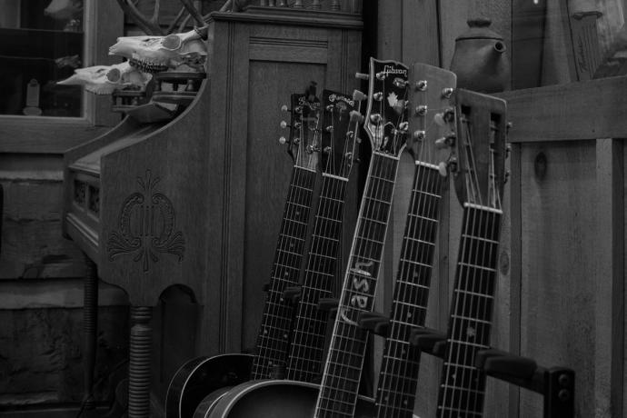 a line of up guitars and a piano