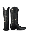 The Annie in Midnight Cowhide. A pair of black midnight cowhide cowboy boots with decorative stitching and small heart-shaped cutouts, shown from the front and side against a white background.