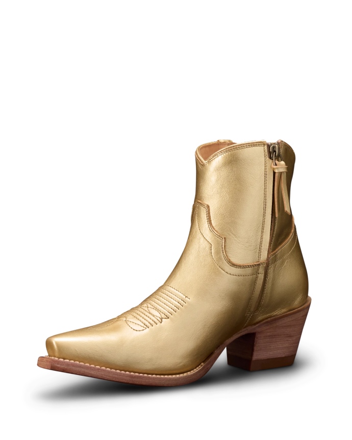 A golden leather ankle boot with a wooden block heel and side zipper, featuring decorative stitching on the upper part.