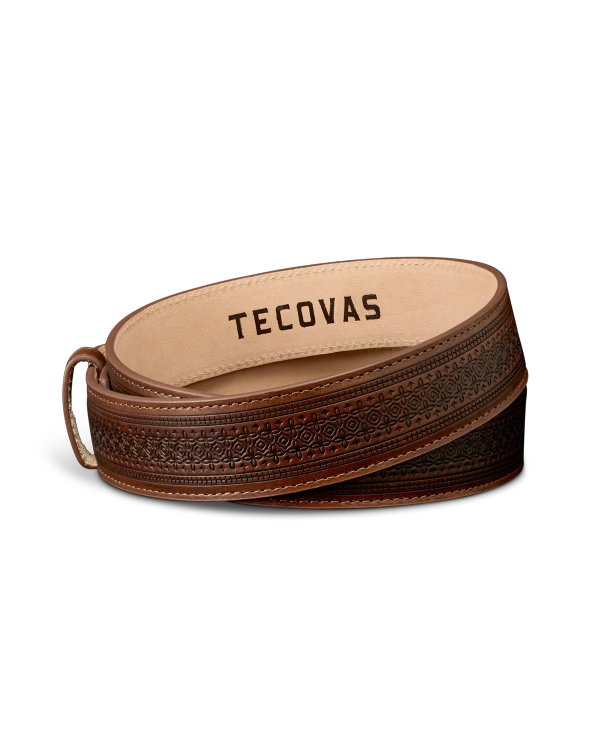 A brown leather belt with an embossed pattern and the word "Tecovas" printed on the inside.