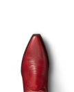 Close-up view of a red cowboy boot with intricate stitching, set against a black background.
