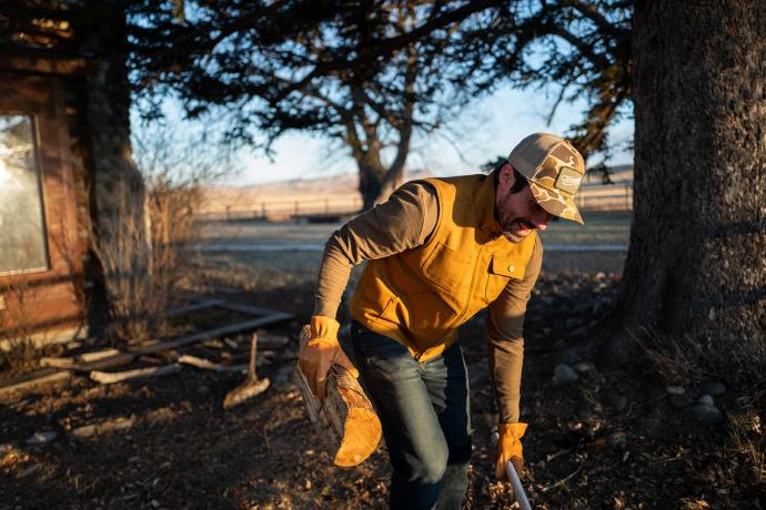 man carrying a log