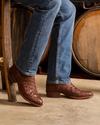 close up picture of Wyatt mahogany boots on a man's feet