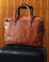 The Bartlett Slim Briefcase over a carryon suitcase.