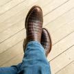 close up picture of Cole Mahogany brown cowboy boots on a man's feet